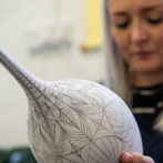 Rhian Malin decorating a mandala bottle in her workshop 2019